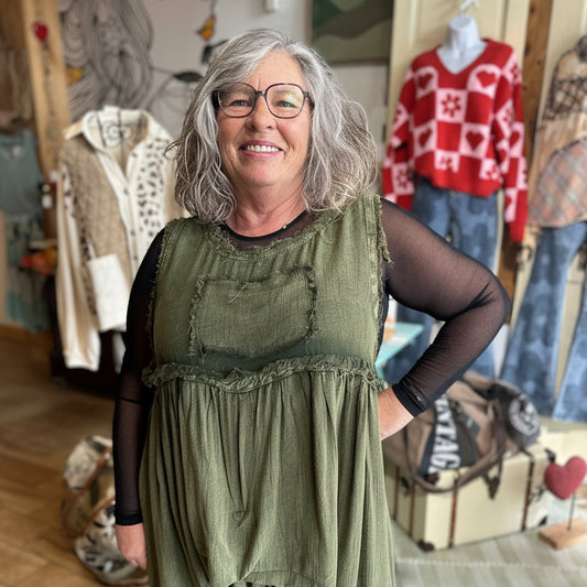 The Sheer Aura Sweetheart top in black, layered for a high-end boutique look.